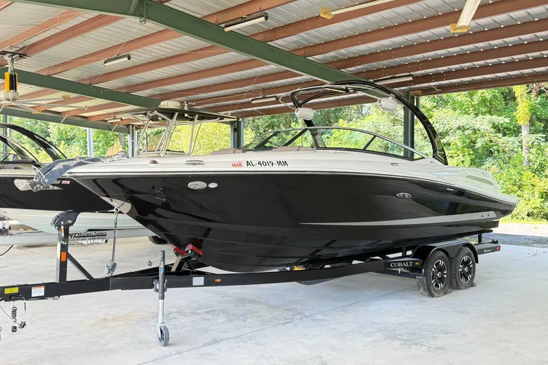 Slide: The Image of 2013 Sea Ray 250 SLX boat on trailer in covered storage area. - 2