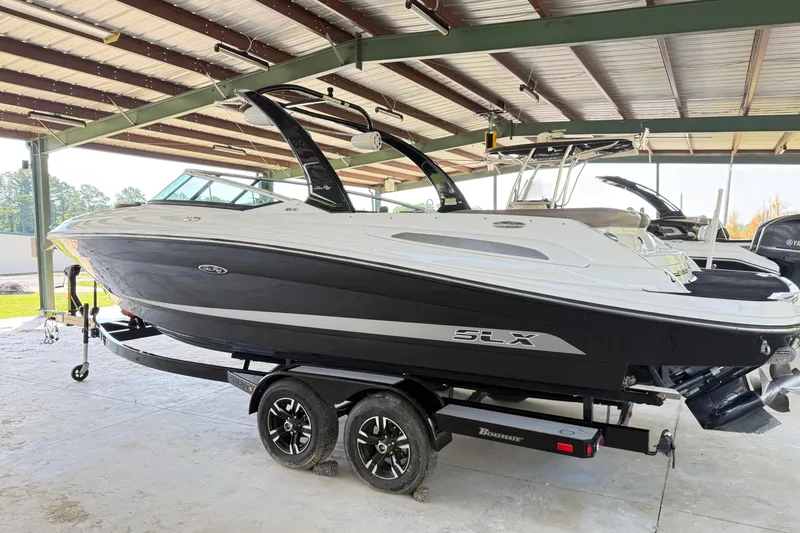 Slide: The Image of 2013 Sea Ray 250 SLX boat on trailer in covered storage area. - 3
