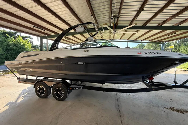 Slide: The Image of 2013 Sea Ray 250 SLX boat on trailer under covered area. - 6