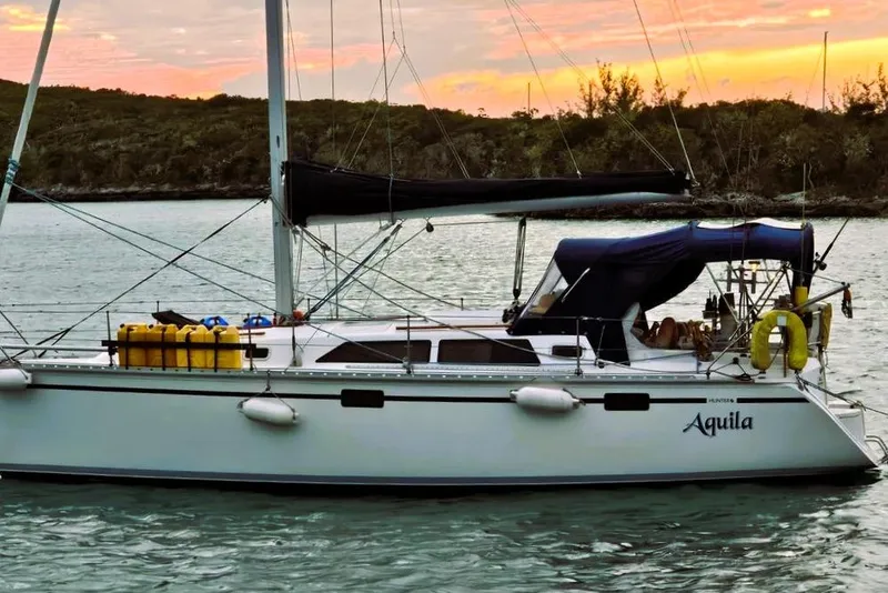 Slide: The Image of Hunter 33.5 sailboat from 1992 named Aquila, anchored at sunset. - 1