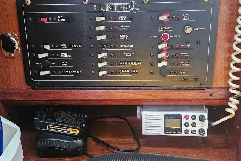 Slide: The Image of Electrical control panel of a 1991 Hunter 34 sailboat with radio and charger. - 13