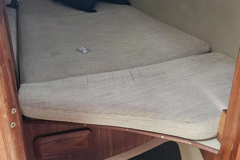 Slide: The Image of Interior cabin of a 1991 Hunter 34 sailboat with cushioned sleeping area. - 14