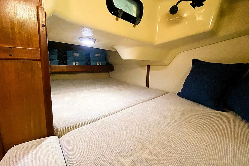 Slide: The Image of Cozy cabin interior of 1992 Hunter 33.5 sailboat with comfortable bedding and storage. - 15