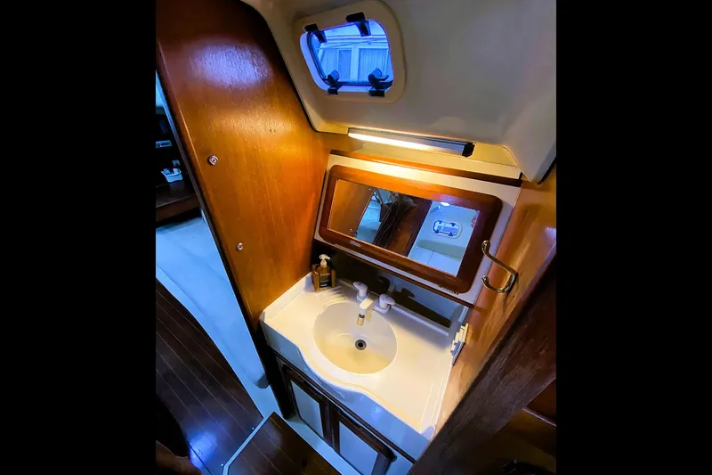 Slide: The Image of 1992 Hunter 33.5 yacht bathroom with wooden cabinetry and compact sink. - 16