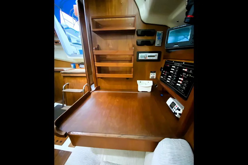 Slide: The Image of Interior of a 1992 Hunter 33.5 sailboat with navigation station and wooden cabinetry. - 17