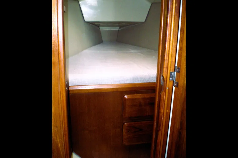 Slide: The Image of Cozy cabin interior of 1992 Hunter 33.5 sailboat with wooden finish and comfortable bedding. - 18