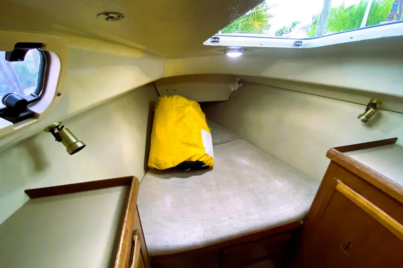 Slide: The Image of Cozy cabin interior of 1992 Hunter 33.5 sailboat with yellow bag and wooden cabinetry. - 19