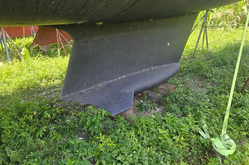 Slide: The Image of Keel of a 1991 Hunter 34 sailboat on grassy ground. - 23