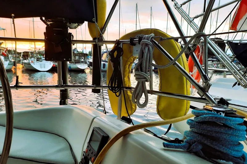 Slide: The Image of Interior view of a 1992 Hunter 33.5 sailboat at sunset, docked in a marina. - 5