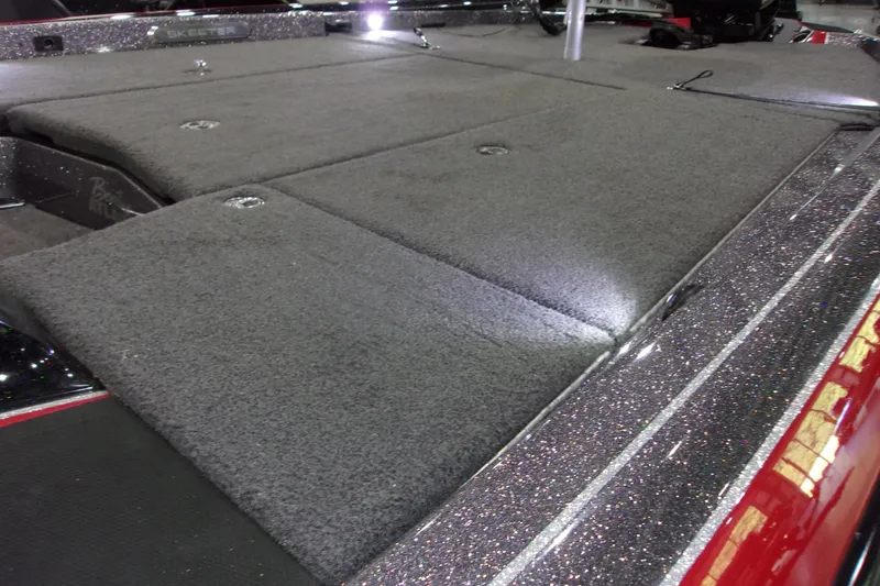 Slide: The Image of 2022 Skeeter boat deck with carpeted surface and metallic trim. - 10