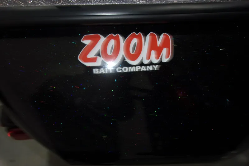 Slide: The Image of Zoom Bait Company logo on 2022 Skeeter boat, black surface with glitter effect. - 12