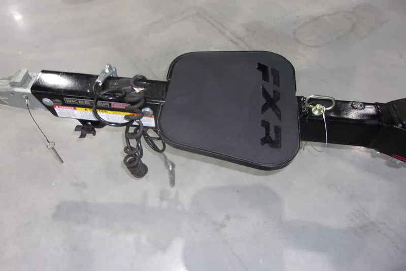 Slide: The Image of 2022 Skeeter FXR trailer hitch with safety cables and lock pin on concrete floor. - 18