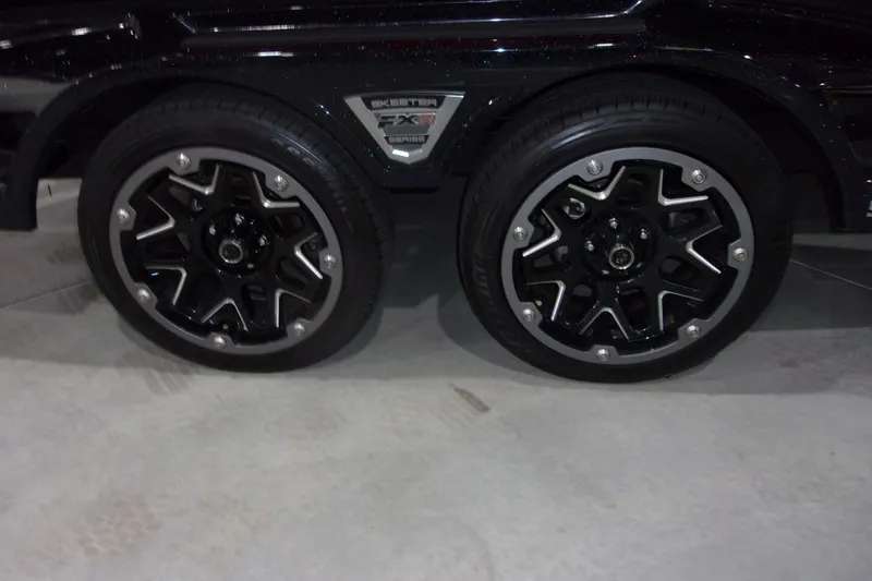 Slide: The Image of Skeeter 2022 model wheels with black and silver alloy rims on concrete floor. - 21