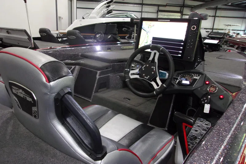 Slide: The Image of 2022 Skeeter boat interior with advanced navigation system and sleek steering console. - 7