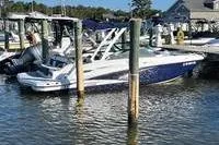 The Image of 2022 Monterey M4 boat docked at a marina with clear skies. - 1