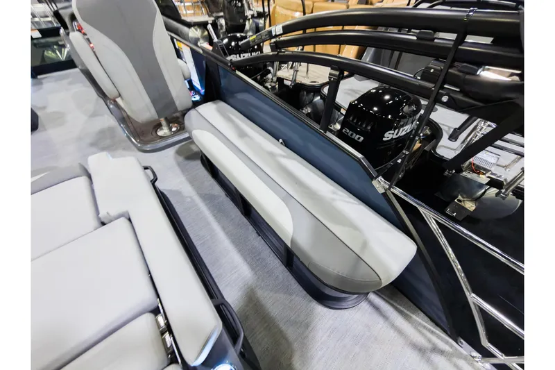 Slide: The Image of 2026 Godfrey Monaco 235 boat interior with flip lounge seating and Suzuki engine. - 26