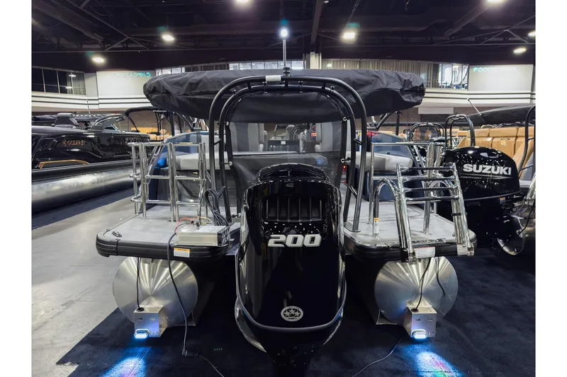 Slide: The Image of 2026 Godfrey Monaco 235 pontoon boat with powerful 200 HP engine displayed indoors. - 28