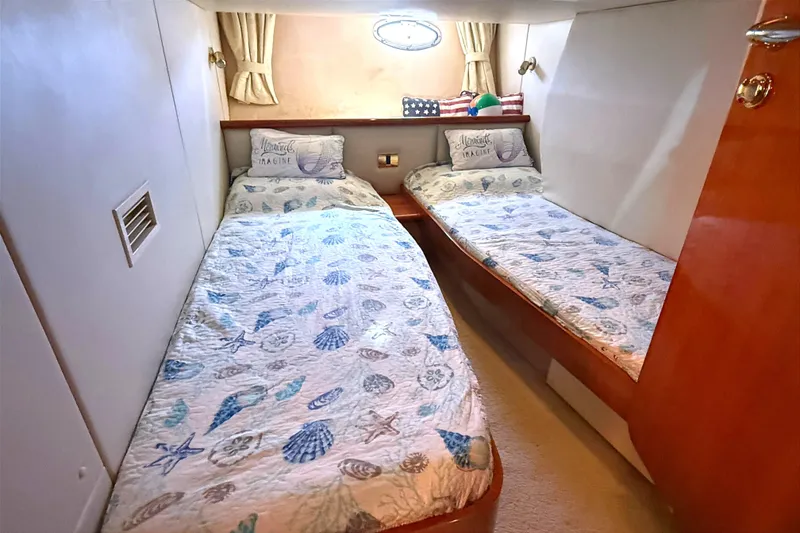 Slide: The Image of Twin cabin in 2002 Sunseeker Camargue 44 yacht with nautical-themed bedding. - 11