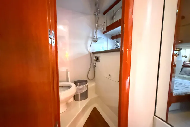 Slide: The Image of Bathroom interior of 2002 Sunseeker Camargue 44 yacht, featuring shower and toilet. - 13
