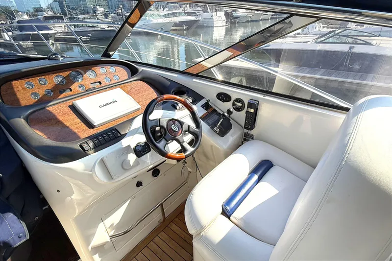 Slide: The Image of Helm of 2002 Sunseeker Camargue 44 yacht with steering wheel and navigation equipment. - 4