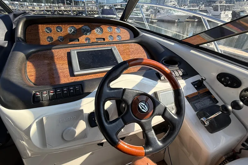 Slide: The Image of Helm of 2002 Sunseeker Camargue 44 yacht with wooden dashboard and steering wheel. - 5