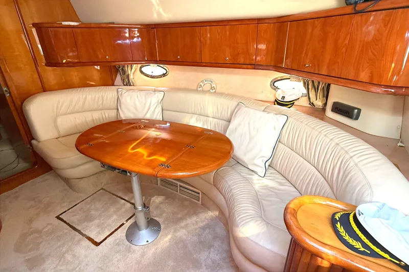 Slide: The Image of Luxurious interior of 2002 Sunseeker Camargue 44 yacht with leather seating and wooden table. - 7