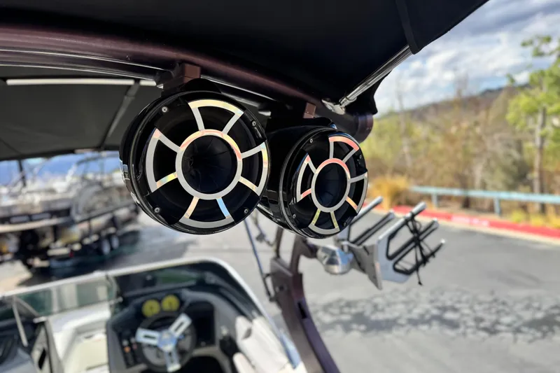 Slide: The Image of 2014 Centurion Enzo SV244 boat speakers and wakeboard rack under canopy. - 11