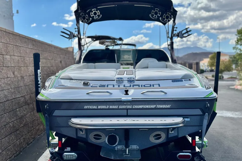 Slide: The Image of 2014 Centurion Enzo SV244 wake surfing towboat, rear view, parked outdoors. - 5