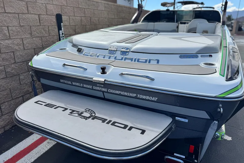 Slide: The Image of 2014 Centurion Enzo SV244 boat, rear view, showcasing wake surfing championship branding. - 7