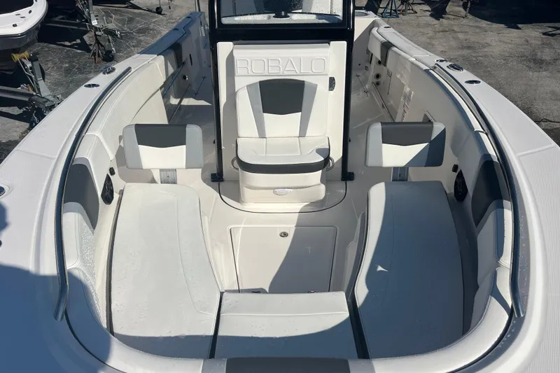 Slide: The Image of 2025 Robalo R270 Center Console boat interior with seating and console view. - 11