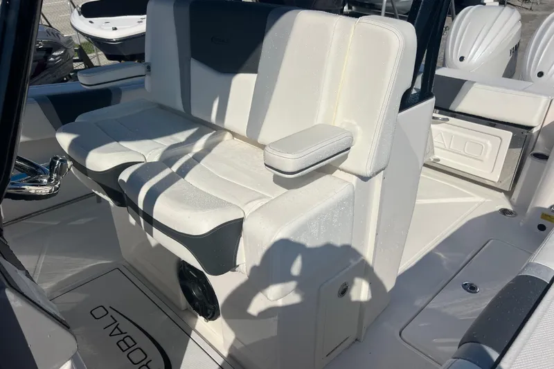 Slide: The Image of 2025 Robalo R270 Center Console boat interior with cushioned seating and armrest. - 14