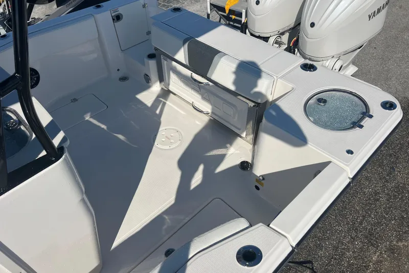 Slide: The Image of 2025 Robalo R270 Center Console boat interior with Yamaha engines, featuring seating and storage. - 15