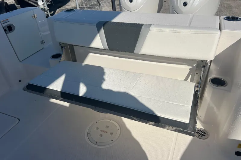 Slide: The Image of 2025 Robalo R270 Center Console boat with foldable seating and cup holders. - 16