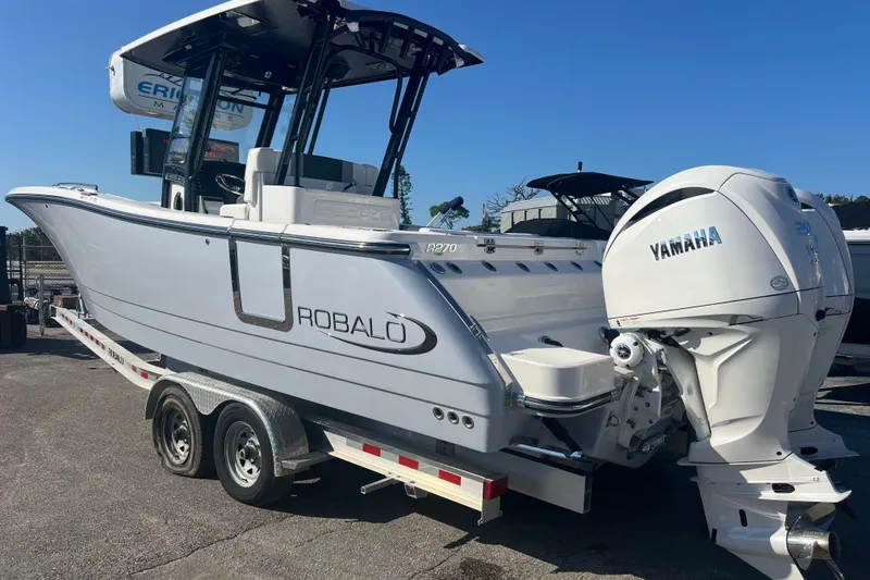 Slide: The Image of 2025 Robalo R270 Center Console boat with Yamaha engine on trailer. - 4