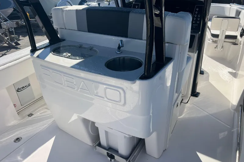 Slide: The Image of 2025 Robalo R270 Center Console boat interior with sink and seating area. - 8