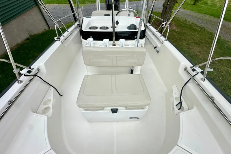 Slide: The Image of 2024 Boston Whaler 170 Montauk interior with seating and console, showcasing spacious design. - 6