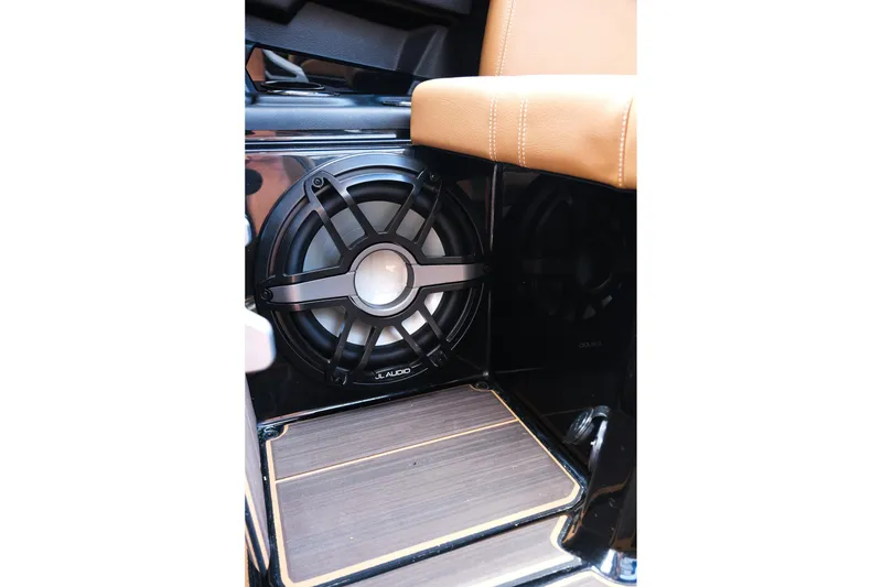 Slide: The Image of 2023 Supra SE550 interior featuring JL Audio speaker and tan leather seating. - 14