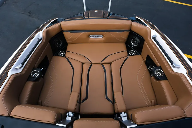 Slide: The Image of 2023 Supra SE550 boat interior with tan leather seating and built-in speakers. - 17