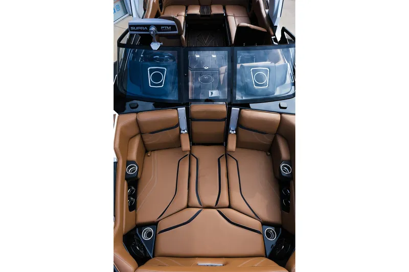 Slide: The Image of 2023 Supra SE550 boat interior with luxurious brown leather seating and modern design. - 20