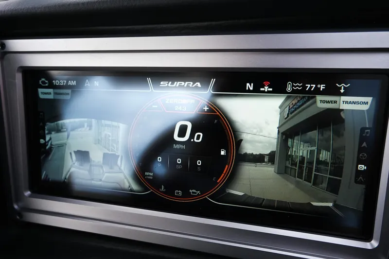 Slide: The Image of 2023 Supra SE550 dashboard display showing speedometer and rearview camera. - 23
