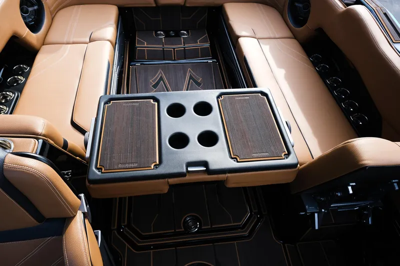 Slide: The Image of Luxurious interior of 2023 Supra SE550 boat with tan seating and sleek table design. - 25