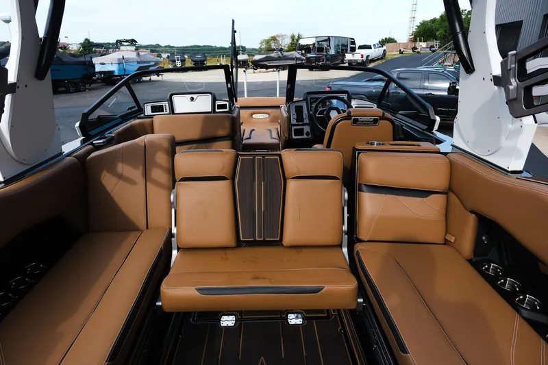 Slide: The Image of 2023 Supra SE550 boat interior with luxurious brown leather seating and modern dashboard. - 26