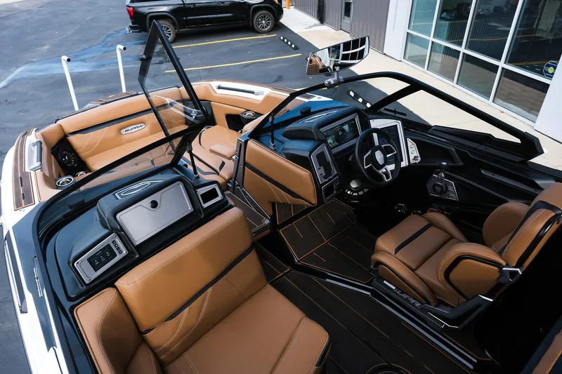 Slide: The Image of 2023 Supra SE550 boat interior with luxurious tan leather seats and modern dashboard. - 30