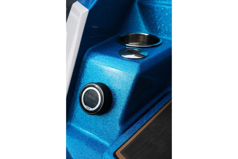 Slide: The Image of 2023 Supra SE550 boat dashboard with blue metallic finish and control knob. - 32