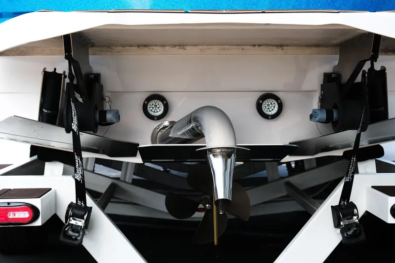 Slide: The Image of Rear view of 2023 Supra SE550 boat, showcasing propeller and exhaust system. - 6