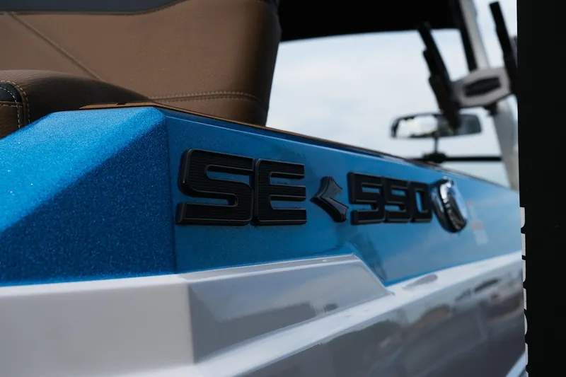 Slide: The Image of 2023 Supra SE550 boat, blue and white exterior, close-up of model name. - 9