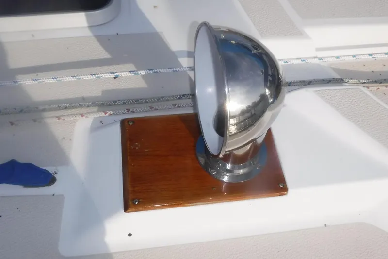 Slide: The Image of Chrome spotlight on 1989 Tartan 37 sailboat deck with wooden base. - 11