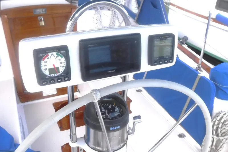 Slide: The Image of 1989 Tartan 37 sailboat helm with navigation instruments and compass. - 15