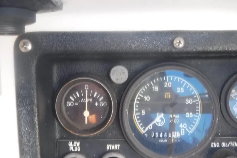 Slide: The Image of Dashboard gauges of a 1989 Tartan 37 sailboat, showing amperes and RPM. - 21