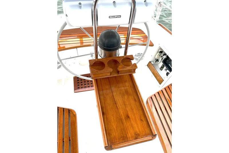 Slide: The Image of 1989 Tartan 37 sailboat cockpit with wooden table and steering wheel. - 27